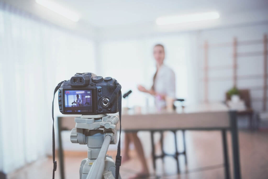 Professional camera filming a girl from a table